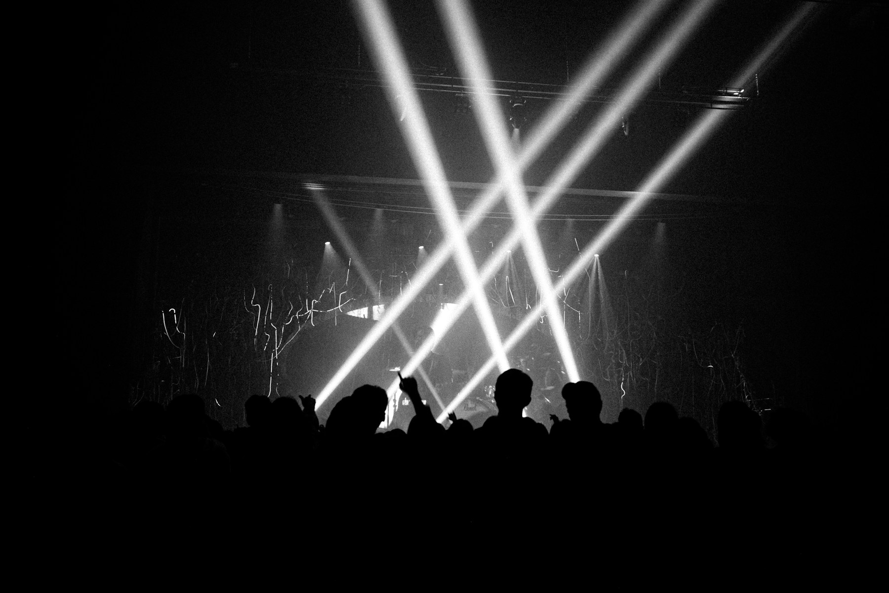 An audience watching a live show beneath bright stage lights